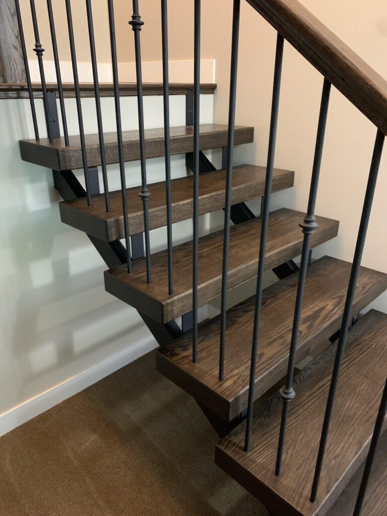 Floating Mono Stringer Stair with an Open Rise and 3" Treads and Metal Spinles with wood top rail