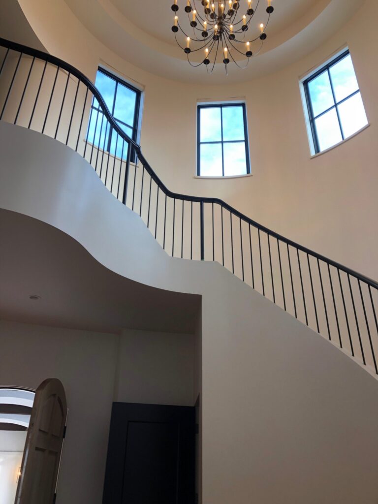 Black welded interior railing with vertical black metal spindles and black handrail