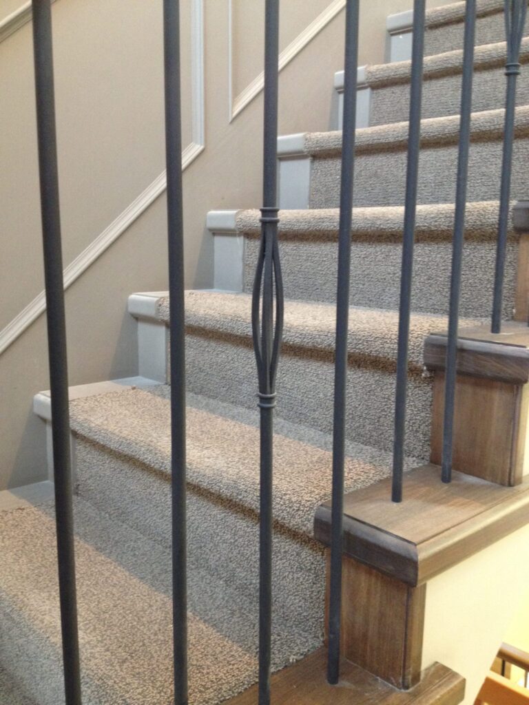 Interior railing with black vertical metal spindles