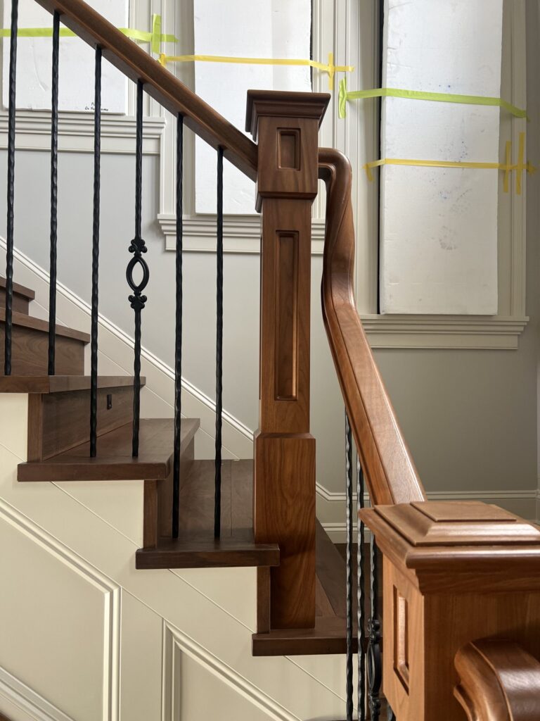 Interior wooden railing with vertical metal spindles