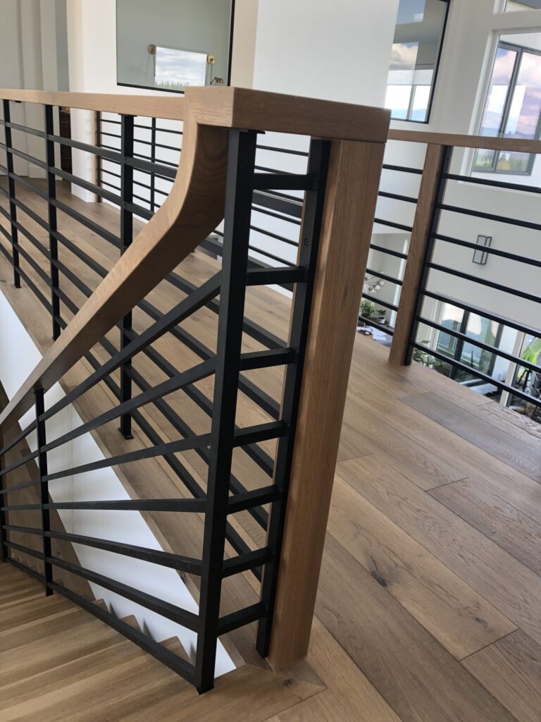 Interior wooden railing and handrail and horizontal metal spindles